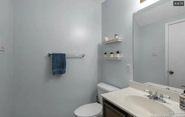 a bathroom with a sink toilet and mirror