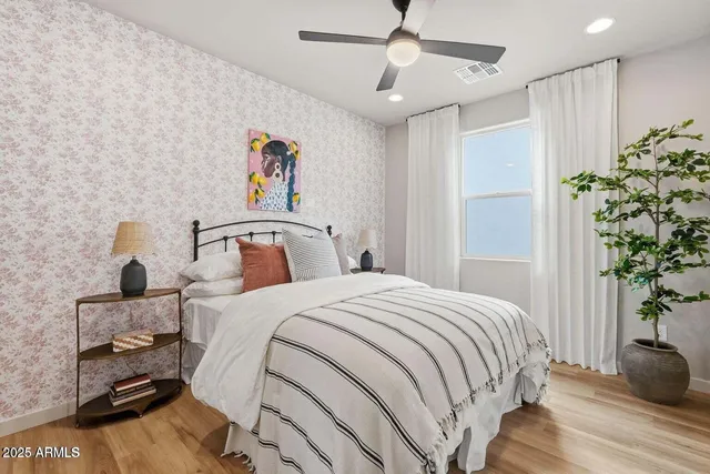 a bedroom with a bed and a potted plant