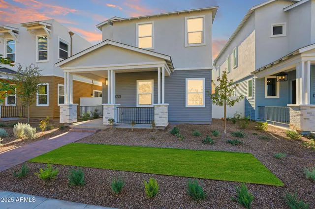 a front view of a house with a yard and outdoor seating