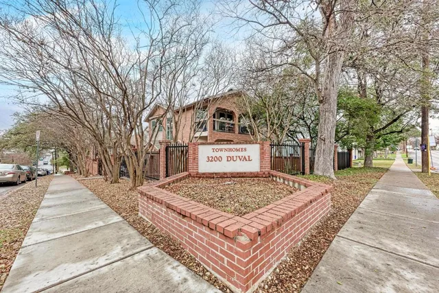 a front view of a house with trees