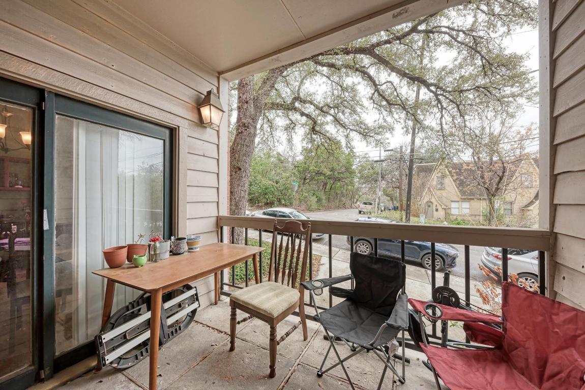 3200 Duval Street, Unit 101 Austin, TX 78705 - Photo 17 of 39 a balcony with wooden floor and outdoor seating