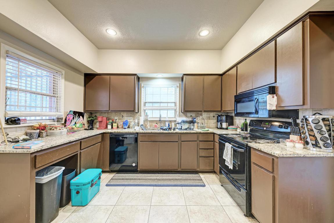 3200 Duval Street, Unit 101 Austin, TX 78705 - Photo 19 of 39 a kitchen with a sink a stove and cabinets