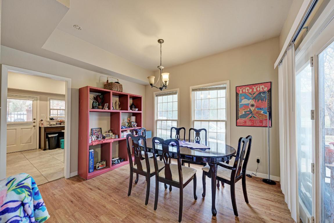 3200 Duval Street, Unit 101 Austin, TX 78705 - Photo 25 of 39 a view of a dining room with furniture and wooden floor