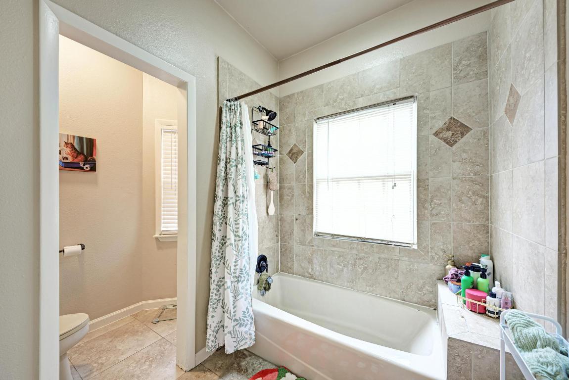 3200 Duval Street, Unit 101 Austin, TX 78705 - Photo 39 of 39 a bathroom with a bathtub a shower and a window