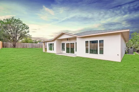 a front view of house with yard and green space