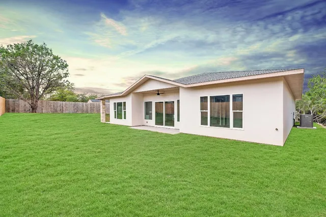 a front view of house with yard and green space