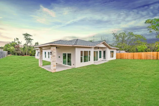 a view of a house with a yard and sitting area