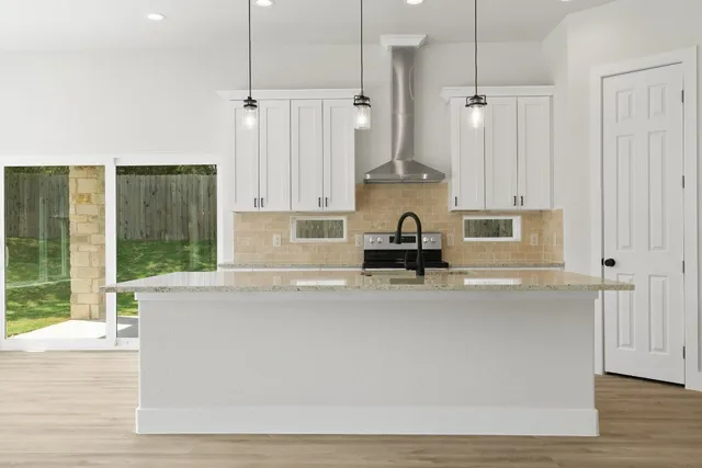 a kitchen with stainless steel appliances a refrigerator a sink and a stove