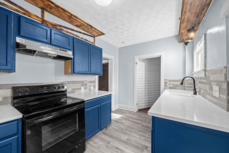 1419 17th Street Moline, IL 61265 - Photo 23 of 28 a kitchen with a stove and a sink