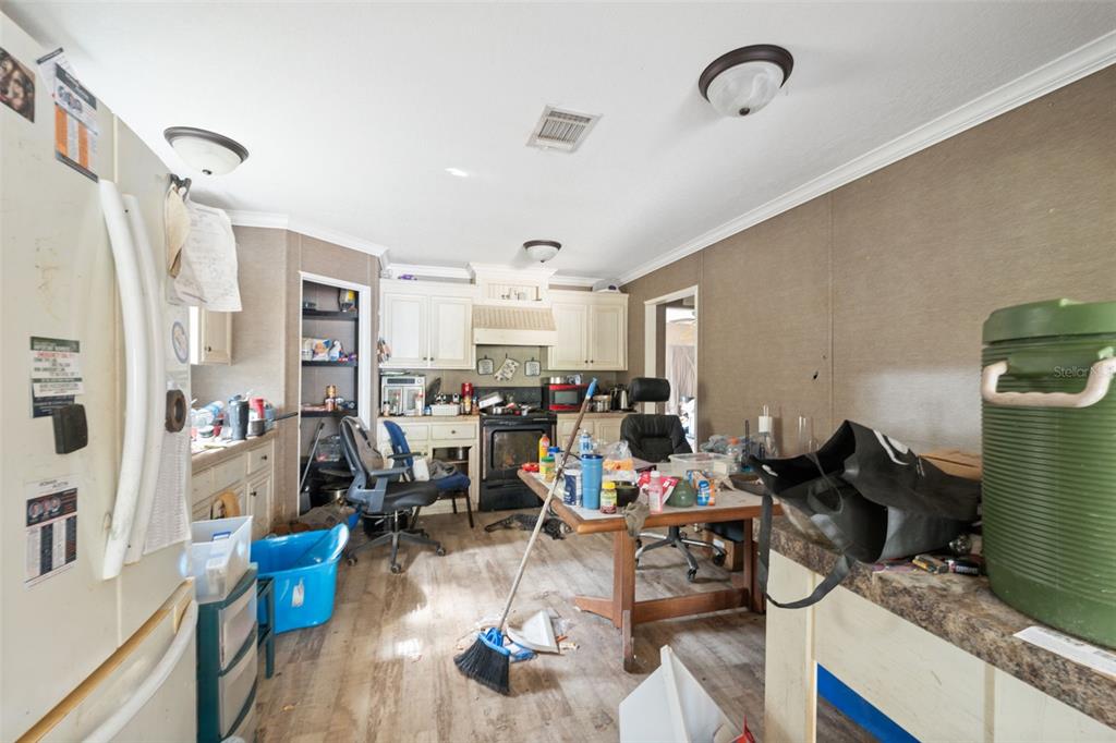 17221 Nicks Drive Spring Hill, FL 34610 - Photo 17 of 33 a living room with lots of furniture and a chandelier