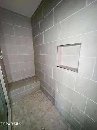 a bathroom with a glass door shower
