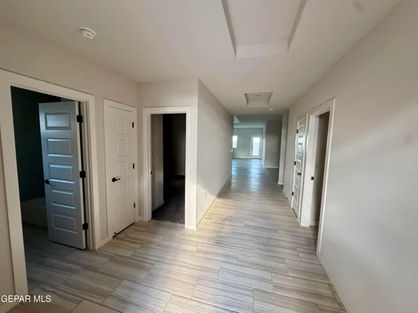 a view of a hallway with wooden floor