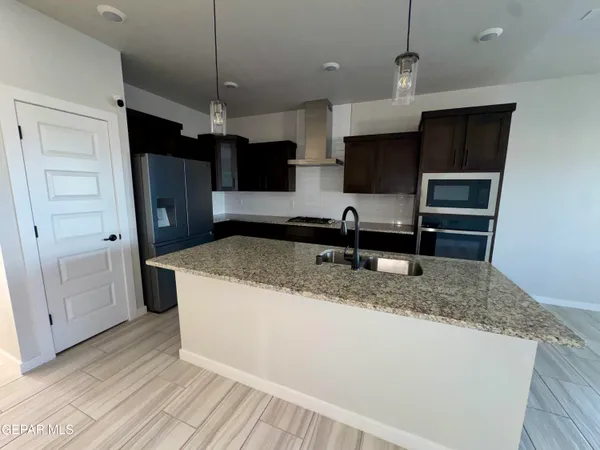 a kitchen with kitchen island a counter top space appliances and cabinets