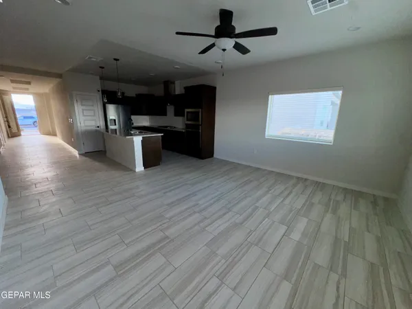 a kitchen with stainless steel appliances kitchen island wooden floors granite counter tops and a window