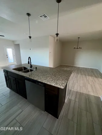 a kitchen with a sink refrigerator and cabinets
