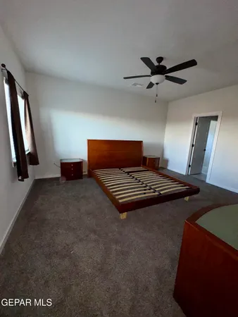 a view of room with furniture and a ceiling fan
