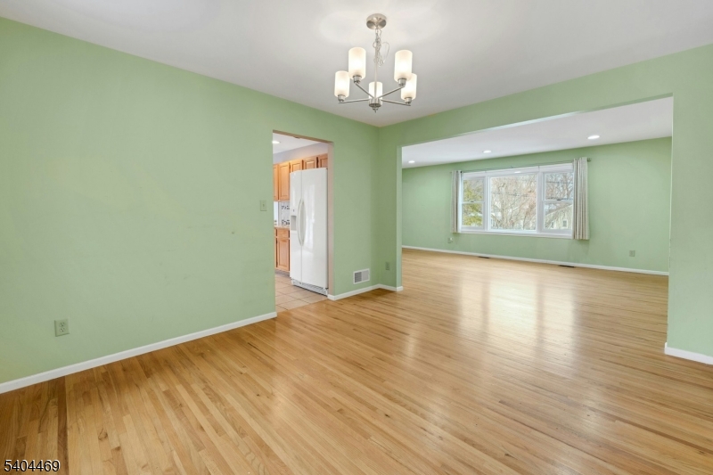 40 White Meadow Road Rockaway, NJ 07866 - Photo 11 of 41 a view of an empty room with wooden floor and a window
