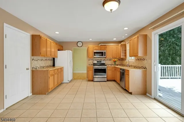 a kitchen with stainless steel appliances granite countertop a stove sink microwave and cabinets