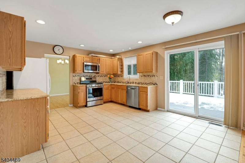 40 White Meadow Road Rockaway, NJ 07866 - Photo 14 of 41 a kitchen with stainless steel appliances granite countertop a stove top oven a sink dishwasher and a refrigerator