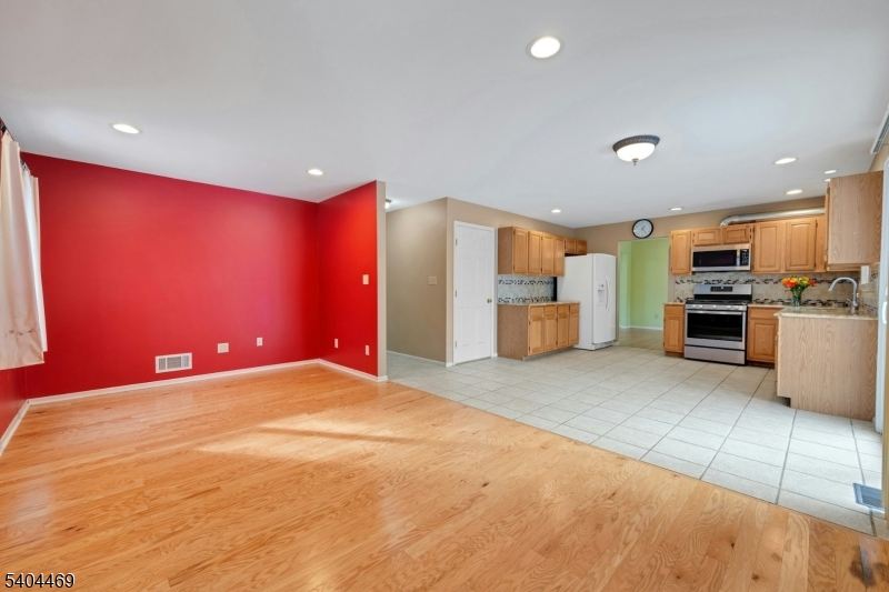 40 White Meadow Road Rockaway, NJ 07866 - Photo 19 of 41 a large kitchen with stainless steel appliances kitchen island granite countertop a refrigerator stove oven a sink with dining table and chairs