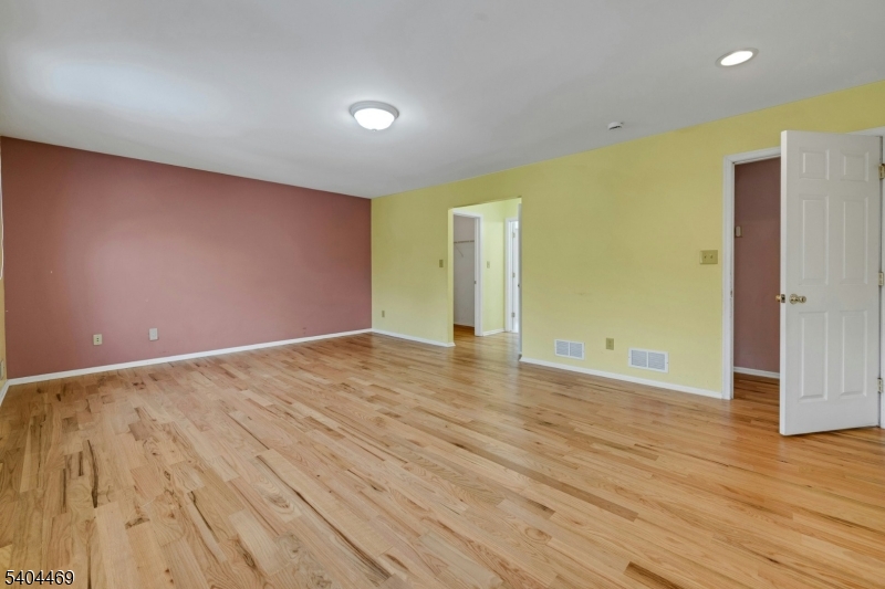 40 White Meadow Road Rockaway, NJ 07866 - Photo 22 of 41 an empty room with wooden floor and windows