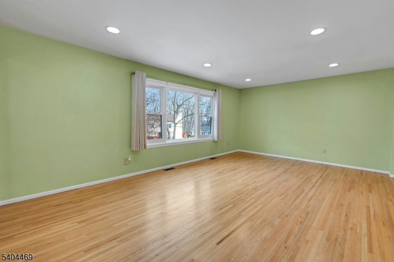 40 White Meadow Road Rockaway, NJ 07866 - Photo 6 of 41 an empty room with wooden floor and windows