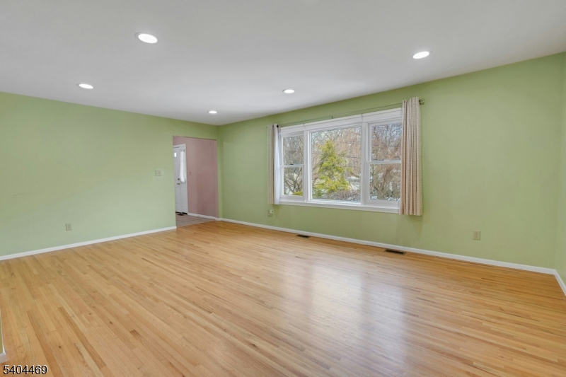 40 White Meadow Road Rockaway, NJ 07866 - Photo 7 of 41 an empty room with wooden floor and window
