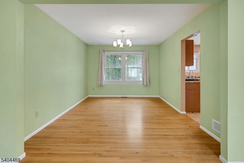 40 White Meadow Road Rockaway, NJ 07866 - Photo 9 of 41 a view of an empty room with wooden floor and a window