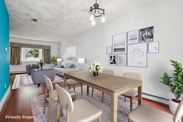 a view of a dining room with furniture window and wooden floor