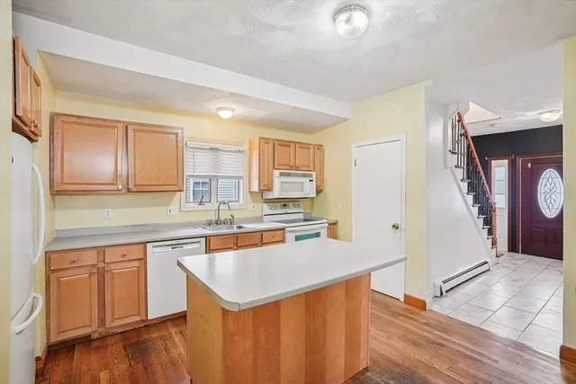 a kitchen with a sink cabinets and wooden floor