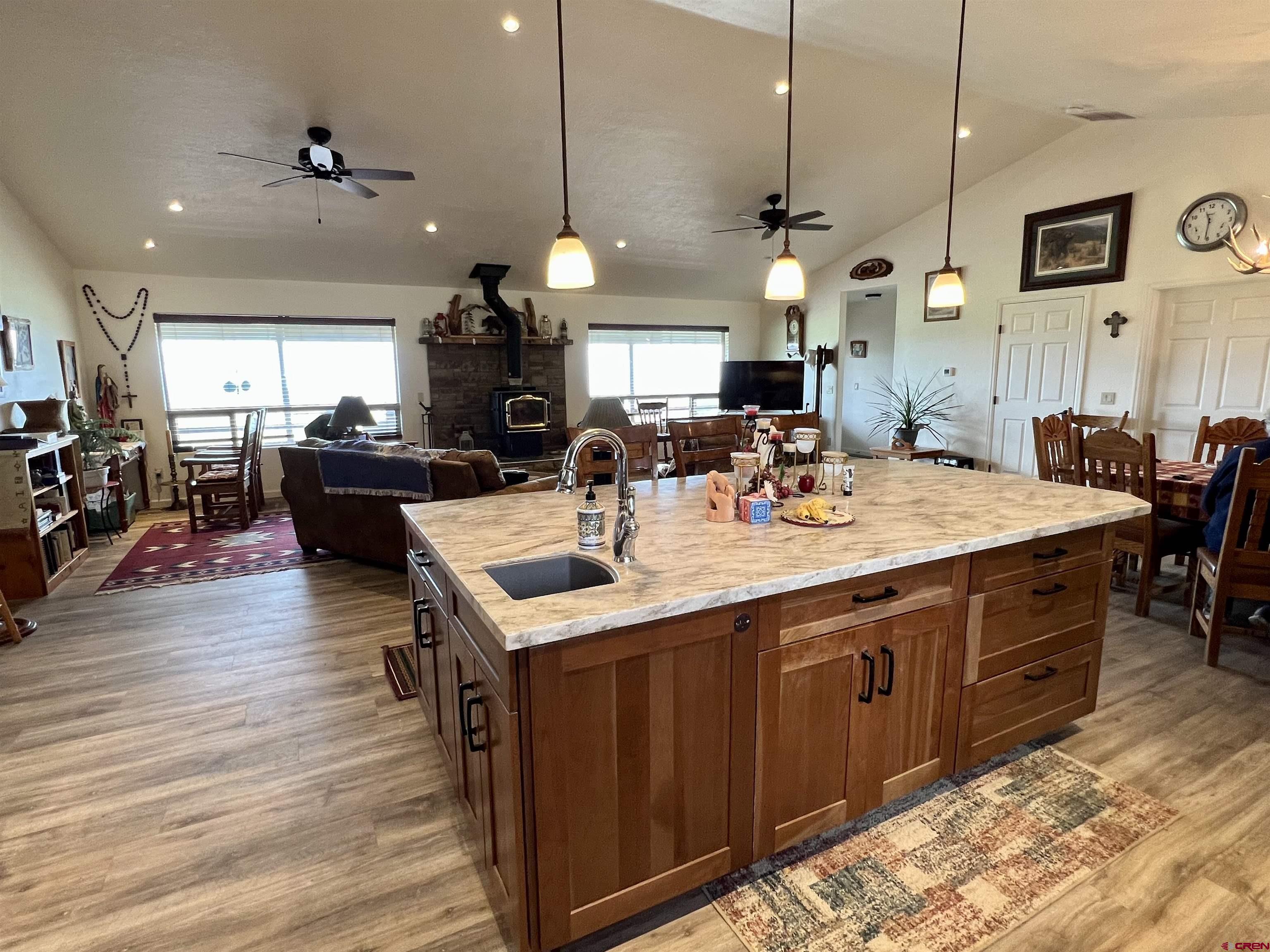 23105 U Road Cedaredge, CO 81413 - Photo 16 of 33 a kitchen with a stove a counter top space a sink a window and living room