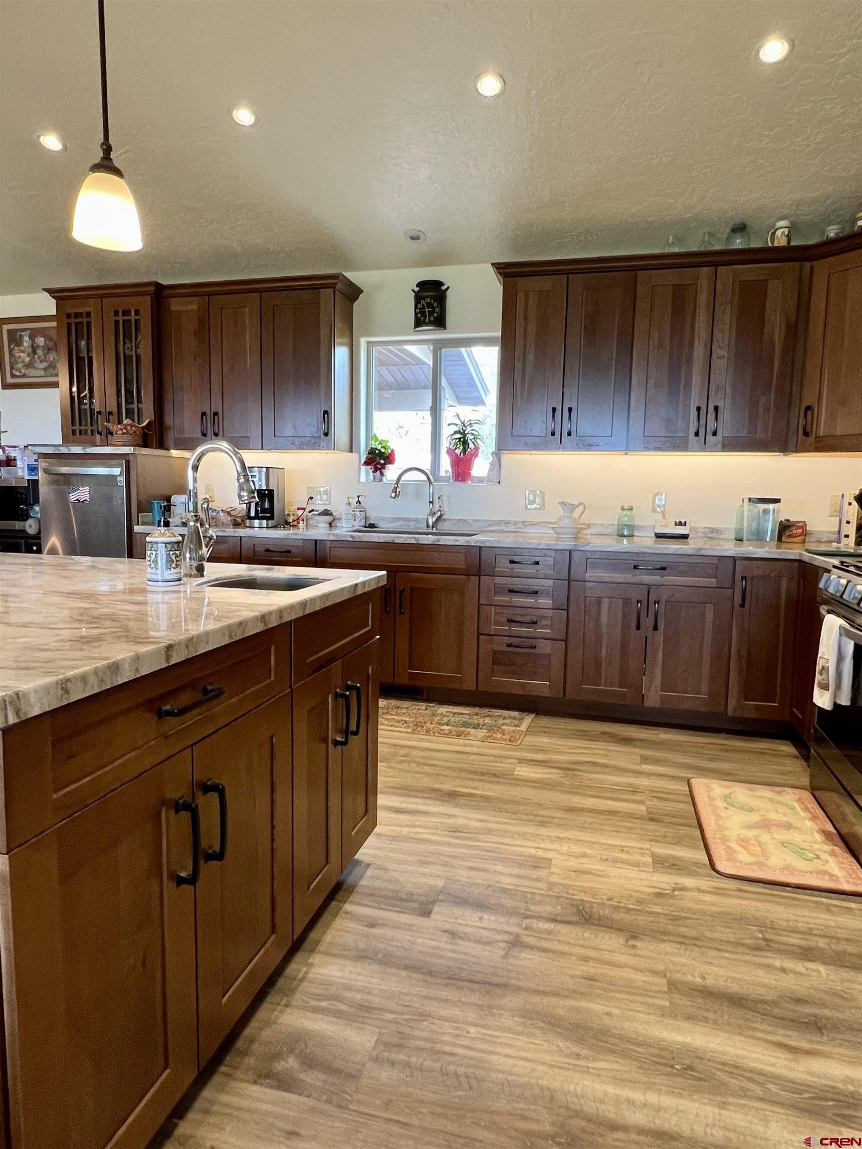 23105 U Road Cedaredge, CO 81413 - Photo 17 of 33 a kitchen with stainless steel appliances granite countertop a sink counter space and cabinets