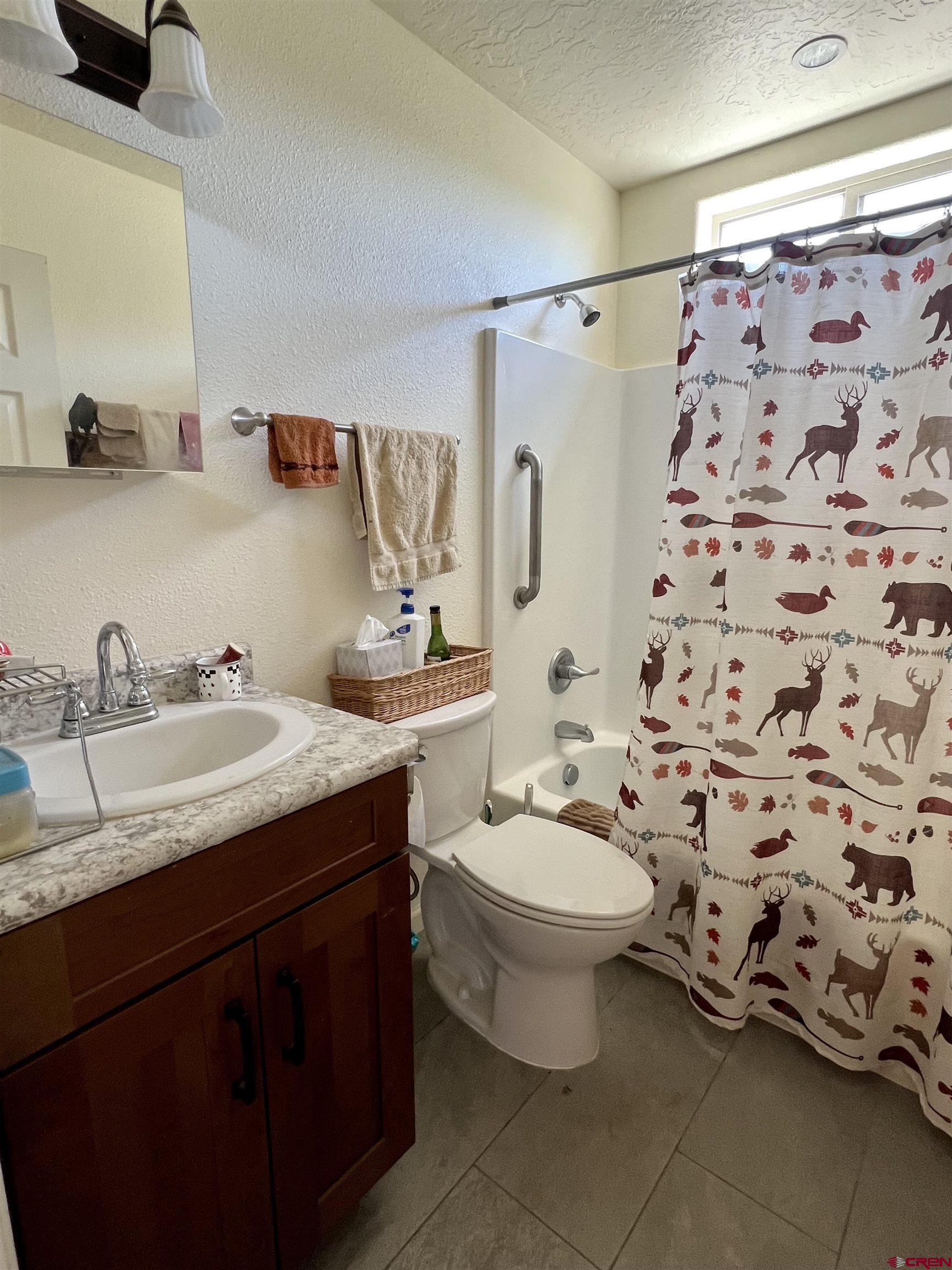 23105 U Road Cedaredge, CO 81413 - Photo 21 of 33 a bathroom with a granite countertop sink and a mirror