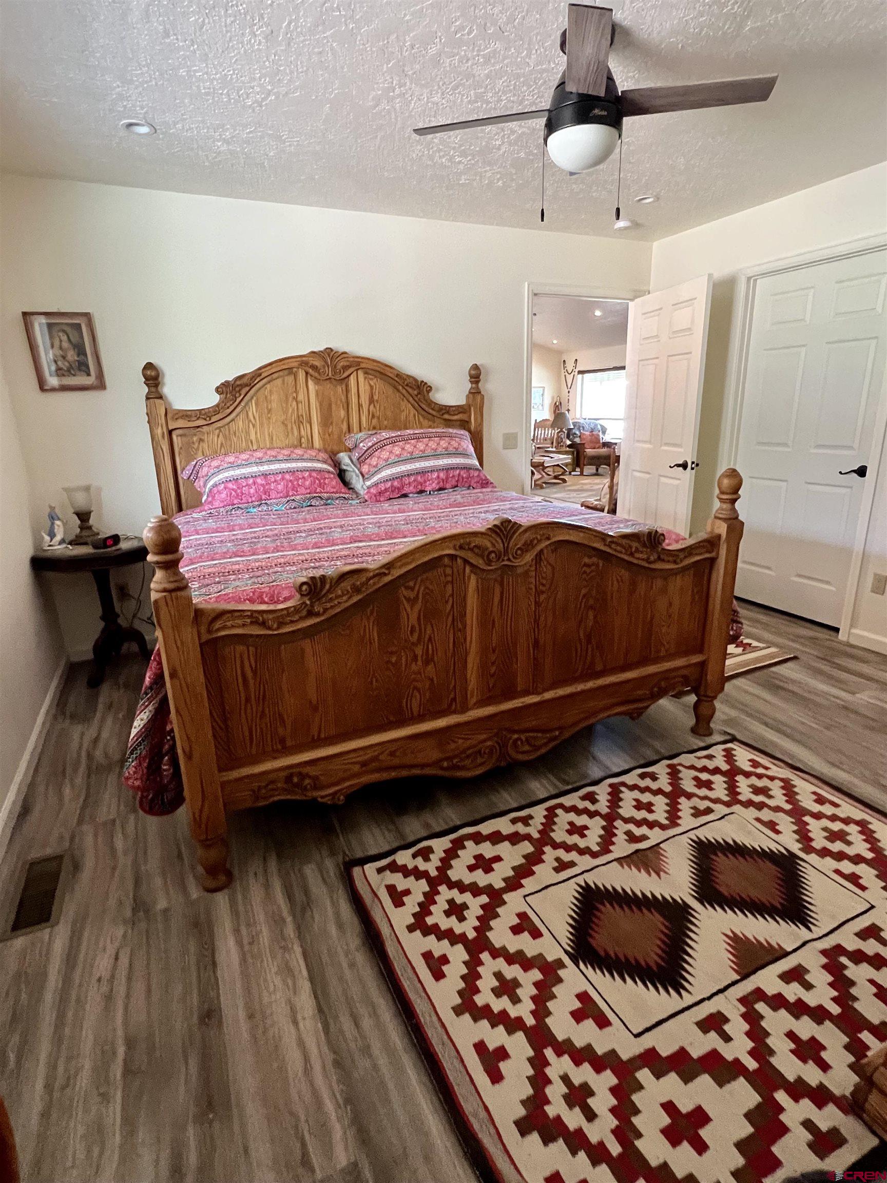 23105 U Road Cedaredge, CO 81413 - Photo 23 of 33 a bedroom with a bed and wooden floor
