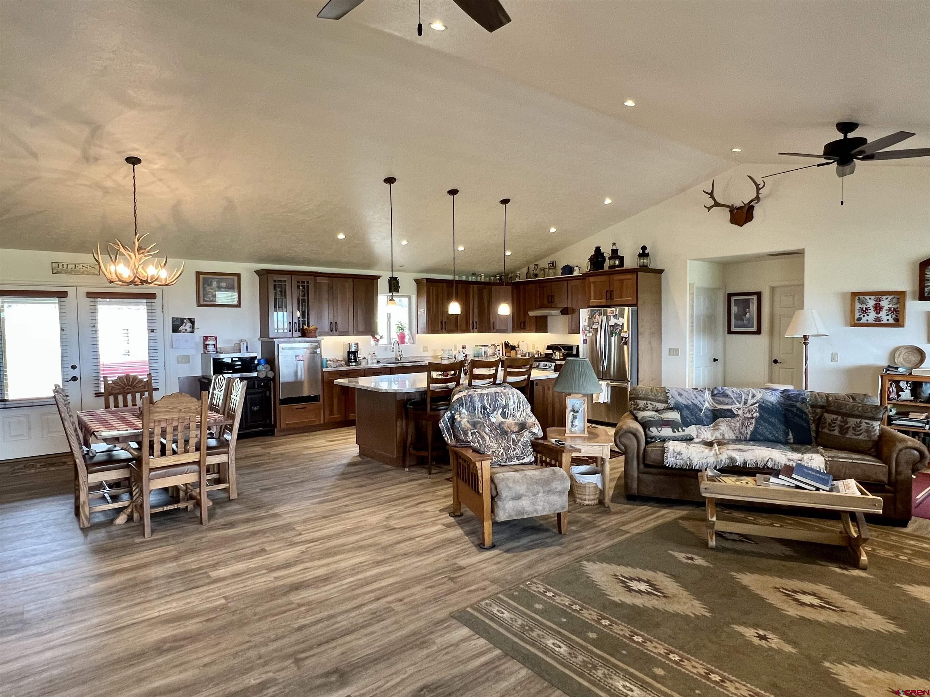 23105 U Road Cedaredge, CO 81413 - Photo 9 of 33 a living room with lots of furniture and a chandelier