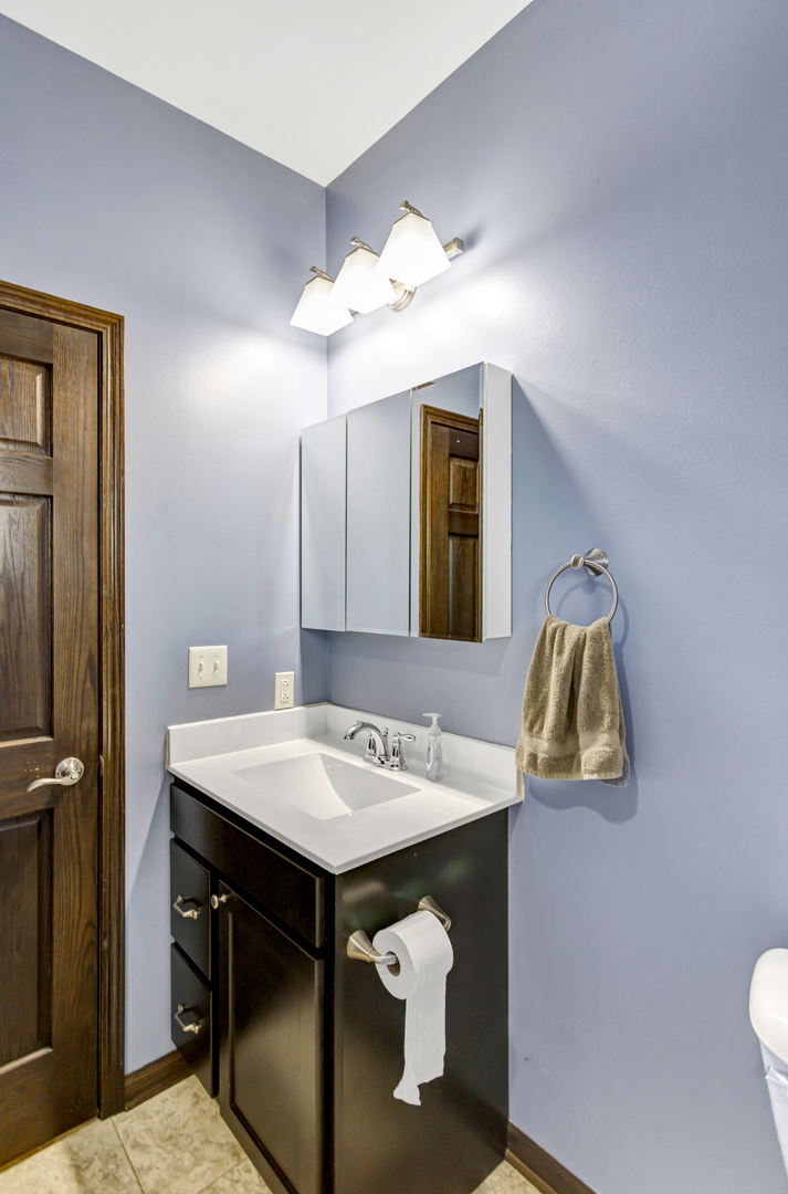 34765 Jefferson Road Genoa, IL 60135 - Photo 33 of 65 a bathroom with a sink vanity and a mirror