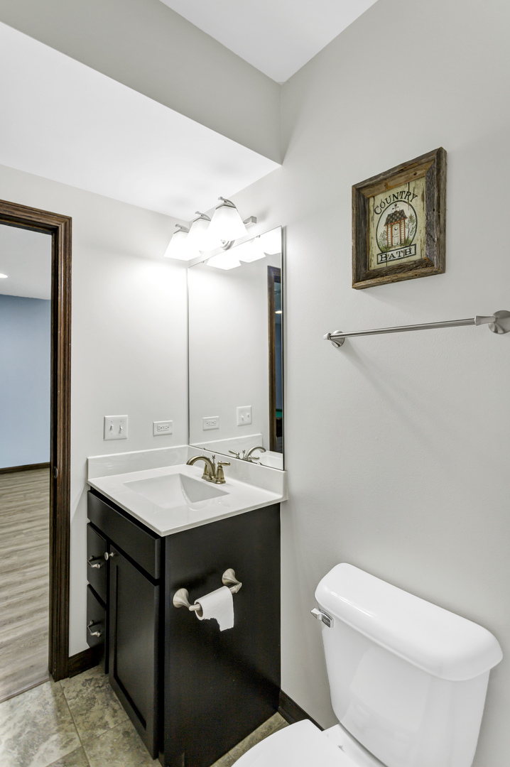34765 Jefferson Road Genoa, IL 60135 - Photo 45 of 65 a bathroom with a toilet sink and mirror