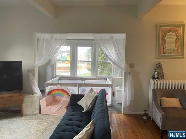 823 Anderson Avenue, Unit 2 Fort Lee, NJ 07024 - Photo 11 of 23 a living room with furniture and a flat screen tv