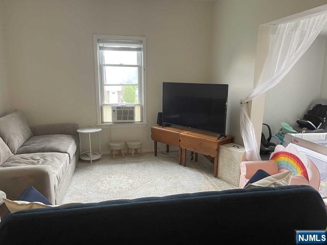 823 Anderson Avenue, Unit 2 Fort Lee, NJ 07024 - Photo 12 of 23 a living room with furniture and a flat screen tv