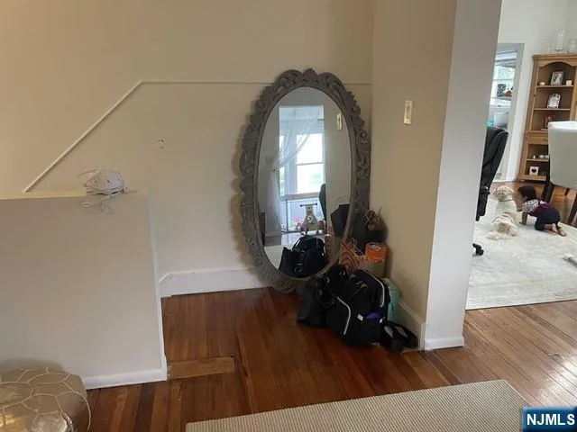 a view of a living room and wooden floor