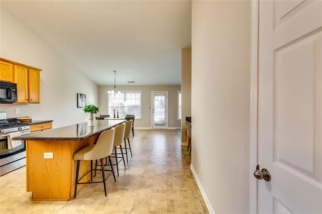 a dining room with furniture and a kitchen