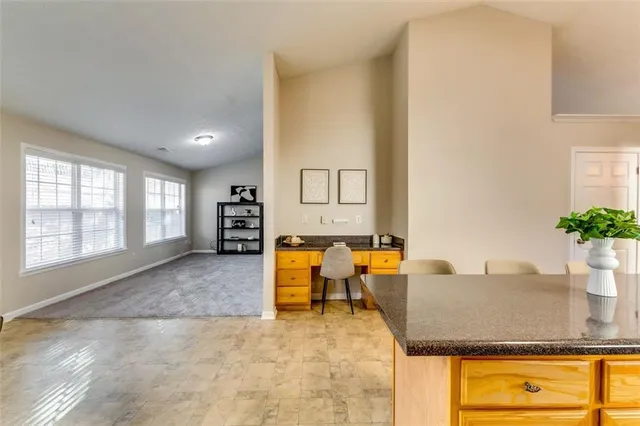 a view of open kitchen with furniture and a potted plant