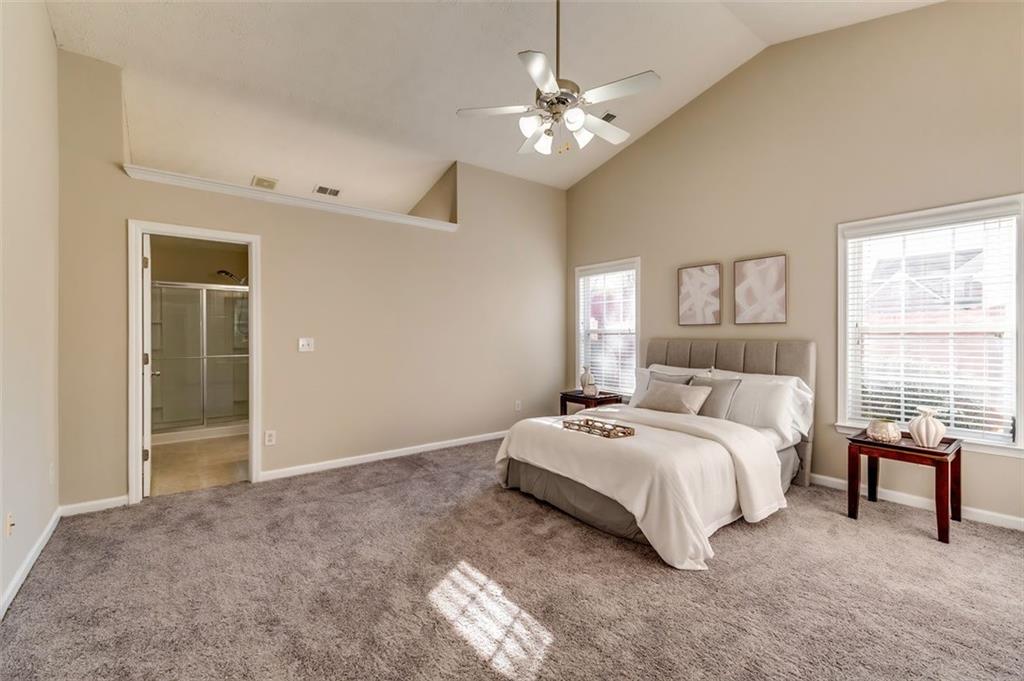 5602 Swanson Road Ellenwood, GA 30294 - Photo 19 of 36 a spacious bedroom with a bed and a table