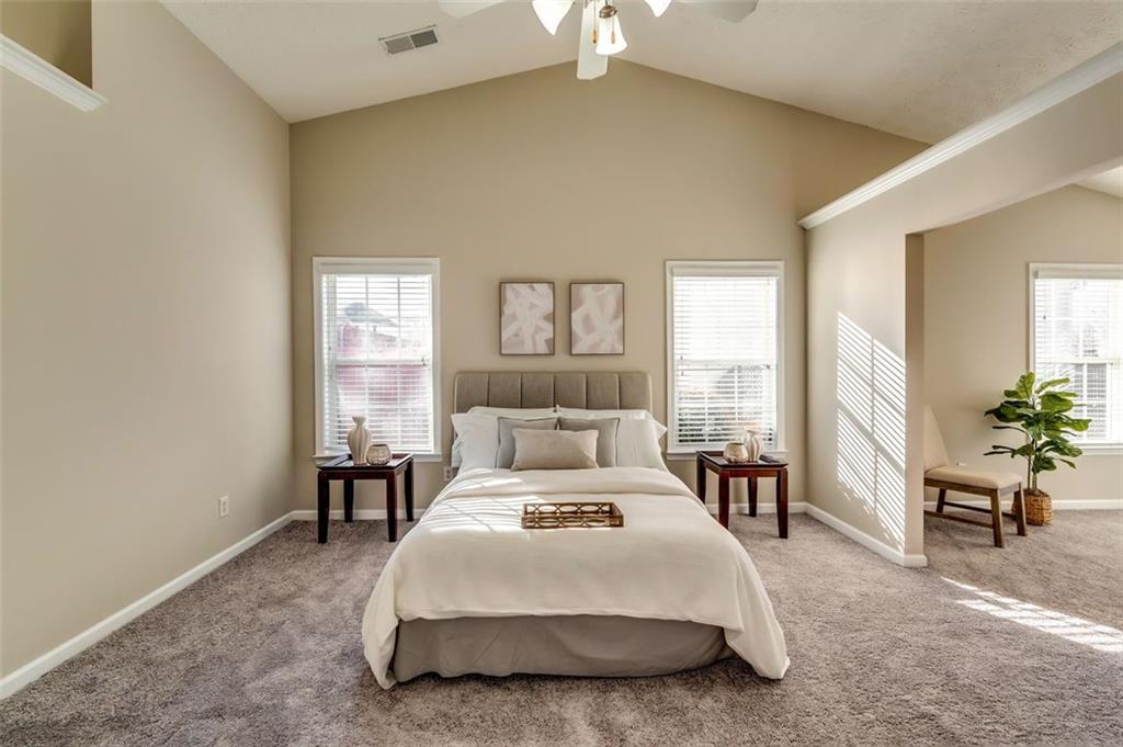 5602 Swanson Road Ellenwood, GA 30294 - Photo 20 of 36 a bedroom with a bed a table and a potted plant