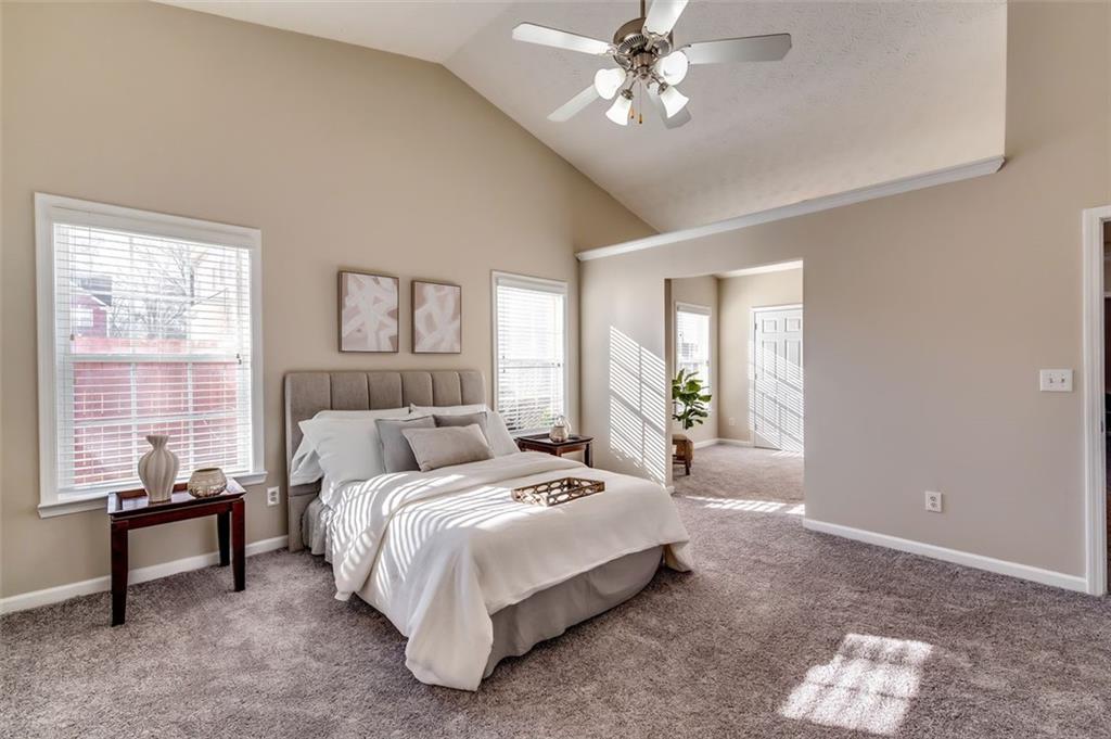 5602 Swanson Road Ellenwood, GA 30294 - Photo 21 of 36 a bed room with a bed and a chandelier