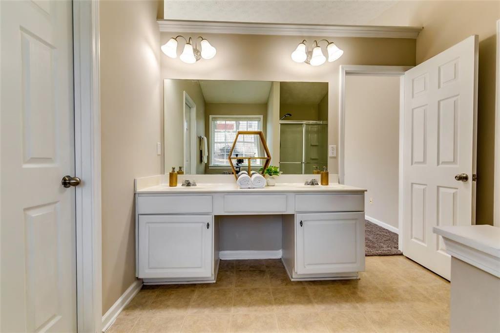 5602 Swanson Road Ellenwood, GA 30294 - Photo 26 of 36 a bathroom with a sink and a mirror