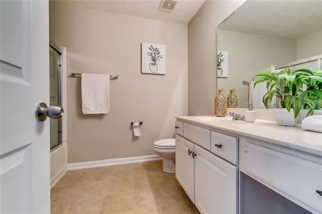 a bathroom with a double vanity sink toilet and a mirror