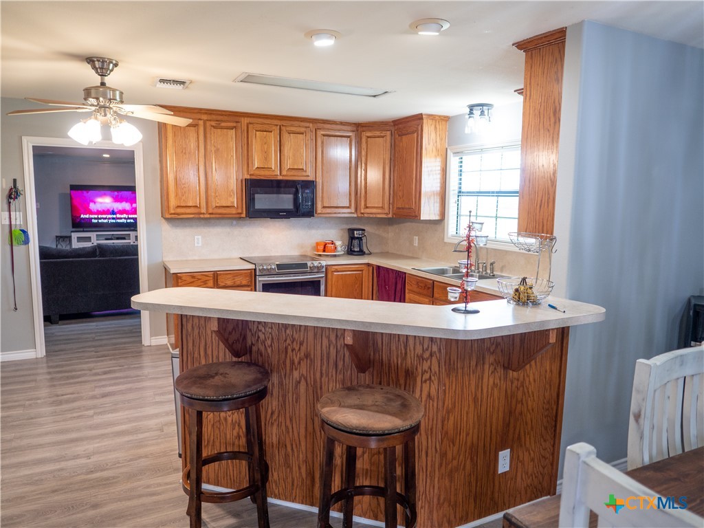 2507 Boyd Road Port Lavaca, TX 77979 - Photo 17 of 47 a kitchen with stainless steel appliances granite countertop a sink and a refrigerator