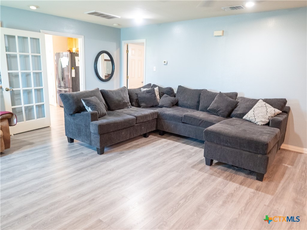 2507 Boyd Road Port Lavaca, TX 77979 - Photo 25 of 47 a living room with couches and a large mirror with wooden floor