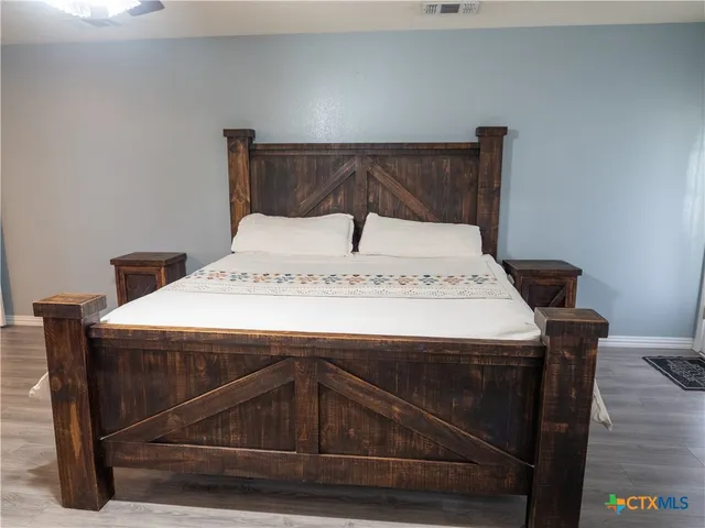 a bedroom with a bed and a mirror